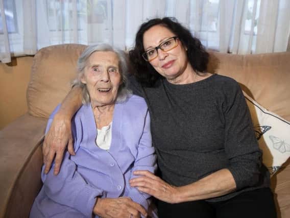 Sylvia Johnson receives support from the Olympus Care specialist dementia team at home. But a review of the service has left her daughter Lynn, right, fearful of her future.