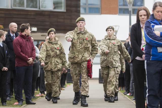 Lead Cadet Emerson Parker, Year 11, read out a war poem before he conducted a drill. He is seen (pictured) with the wreath he laid before an art piece of a Tommy Silhouette the school made. Pictures: Kirsty Edmonds.