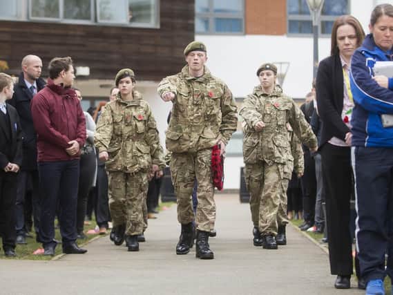 Lead Cadet Emerson Parker, Year 11, read out a war poem before he conducted a drill. He is seen (pictured) with the wreath he laid before an art piece of a Tommy Silhouette the school made. Pictures: Kirsty Edmonds.