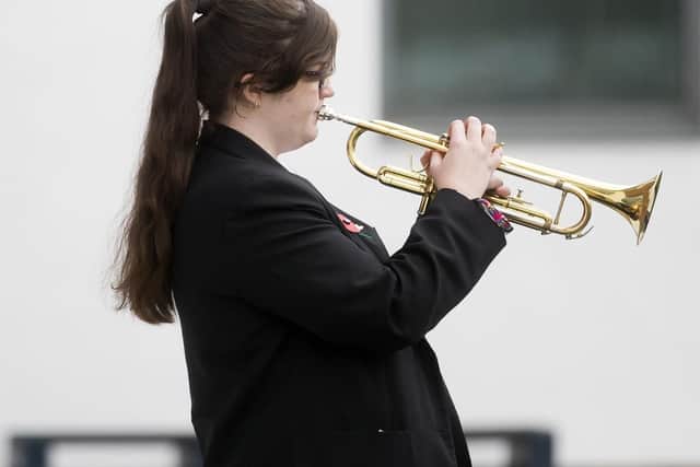 The Last Post was played by Year 11 Kim Sheriff to a silent crowd of onlookers at the Duston School at 11am yesterday morning. Pictures: Kirsty Edmonds.