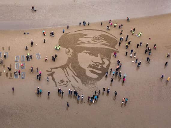 A sand portrait of Walter Tull has been drawn in Scotland as he is remembered 100 years on. Credit: SWNS.