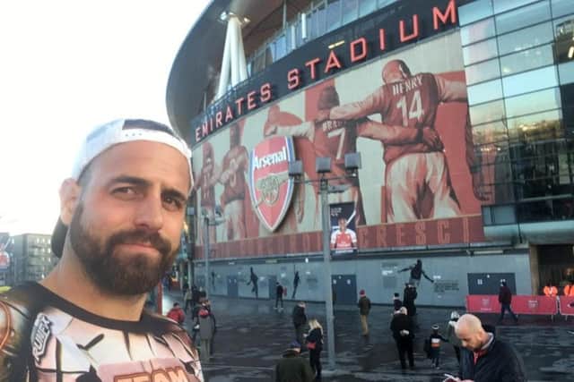 Chris pictured at his last football ground - the Emirates Stadium after 12 gruelling hours of running for his best mate.