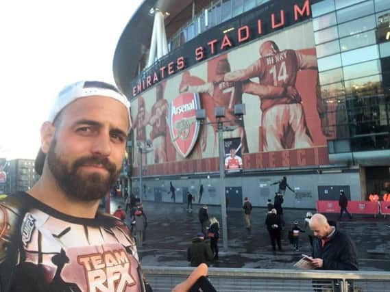 Chris pictured at his last football ground - the Emirates Stadium after 12 gruelling hours of running for his best mate.