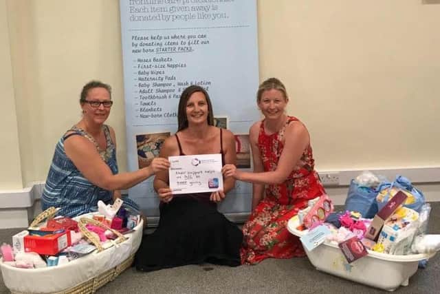 Volunteers from Baby Basics pack up lifeline starter packs for new mums and babies in need with donations from the general public.