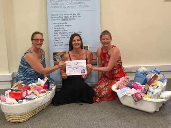 Volunteers from Baby Basics pack up lifeline starter packs for new mums and babies in need with donations from the general public.