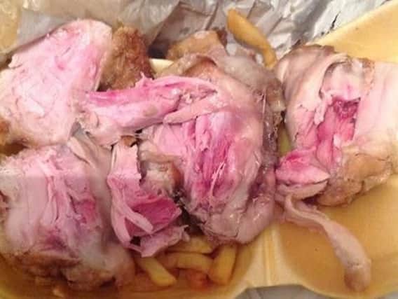 This picture shows raw chicken sent to the family of six on Thursday night. The chicken was part of a 7.99 meal deal which included three chicken wings, three chicken thighs, a can of drink and chips.
