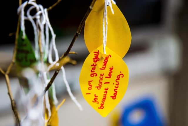 Children are asked to write a message each session for the gratitude tree.