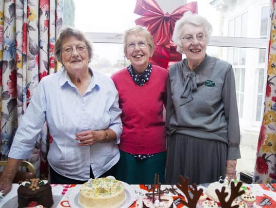 Pictured L-R: Pam Andrews, Dorothy Bonsall and Judy Maloney.
The Christmas themes on the cakes went from the contemporary to traditional snowy Christmas scenes, a reindeer complete with antlers, a Christmas parcel with bright red bow, a Christmas pudding and a snowman's head all of which helped the cake stall to raise over 200 on it's own.