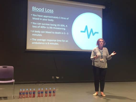 The talk used bottles of water to demonstrate how much blood is in a human body - and how little someone needs to lose to die.