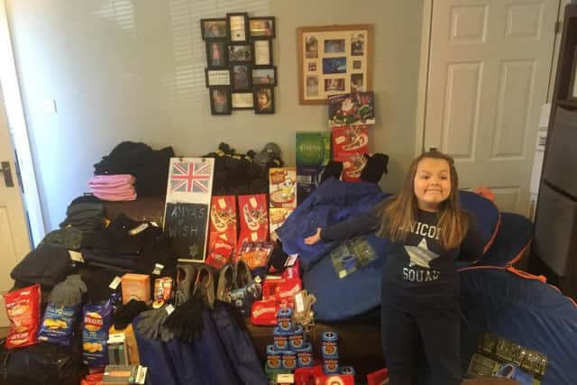 Awesome Anya is pictured here with some of her donations for the homeless community.