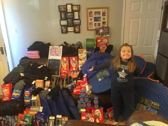 Awesome Anya is pictured here with some of her donations for the homeless community.