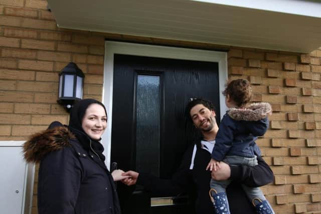 Aimee, Mohammed and Usif, aged 2, outside their new home in Little Cross Street.