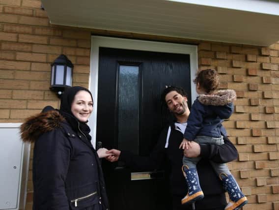 Aimee, Mohammed and Usif, aged 2, outside their new home in Little Cross Street.