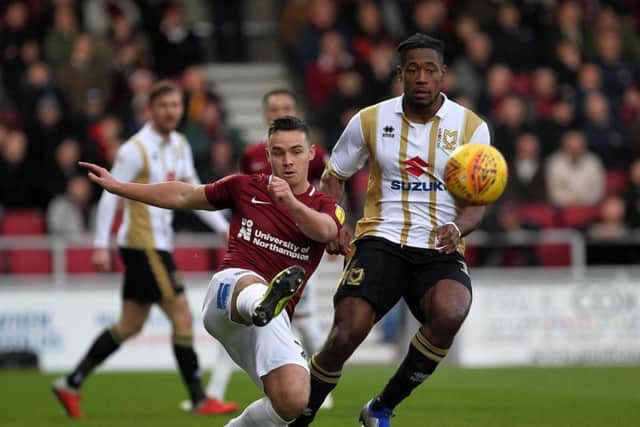 Billy Waters clears the danger under pressure from Chuks Aneke
