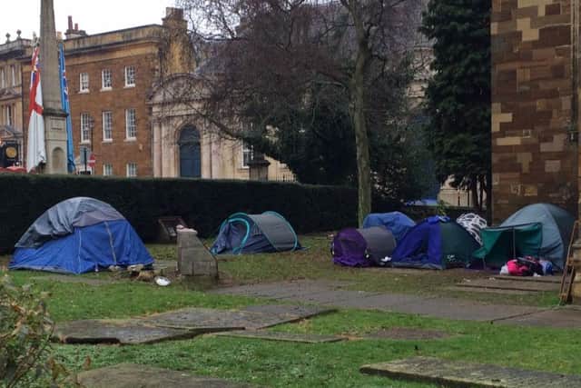 An encampment of tents has pitched up on the graveyard of All Saints Church. (photo taken December 27).