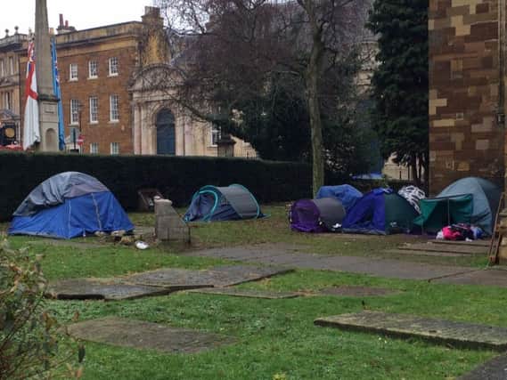 An encampment of tents has pitched up on the graveyard of All Saints Church. (photo taken December 27).