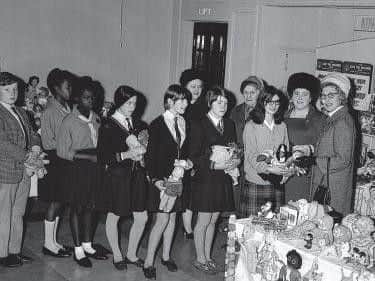It's October 26, 1967 and the Northampton Mayoress, possibly Mrs T H Dockrell, receives toys on behalf of charities in the Odeon Cinema foyer