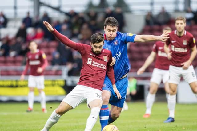 Jack Bridge tussles with Carlisle United's Anthony Gerrard (Pictures: Kirsty Edmonds)