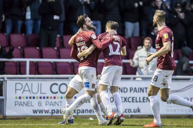 Cobblers celebrate one of Jack Bridge's two goals against Carlisle on Saturday. Picture: Kirsty Edmonds