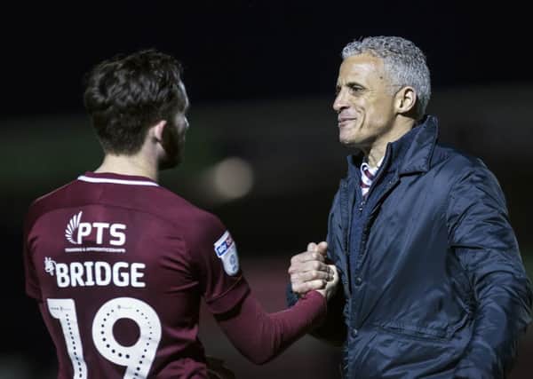 Cobblers boss Keith Curle congratulates Jack Bridge following his man-of-the-match performance against Carlisle (Picture: Kirsty Edmonds)