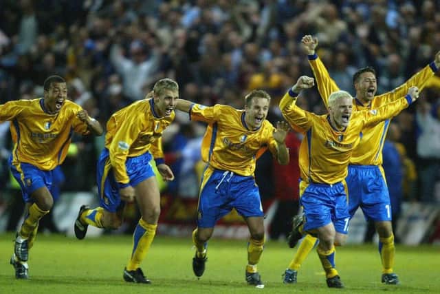 Mansfield's players celebrate their penalty shootout win over the Cobblers