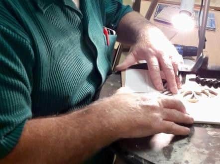 A member at work on a scroll saw.