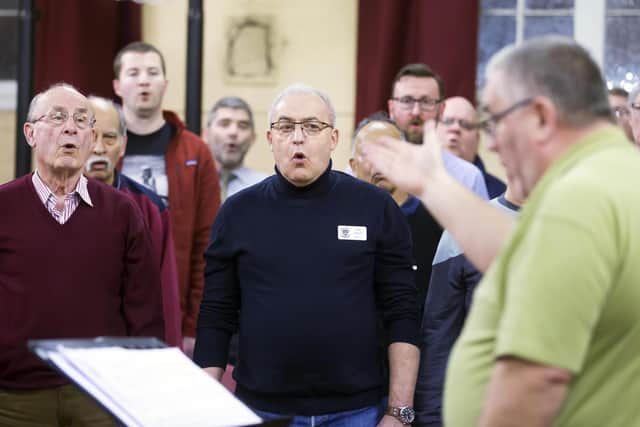 Assistant musical director Andrew Howes pictured conducting the singers.