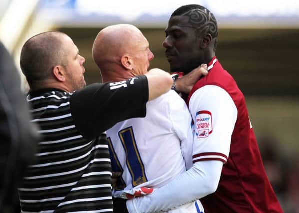 Kevin Ellison 'enjoys' a tussle with Cobblers striker Bas Savage at Sixfields back in 2011