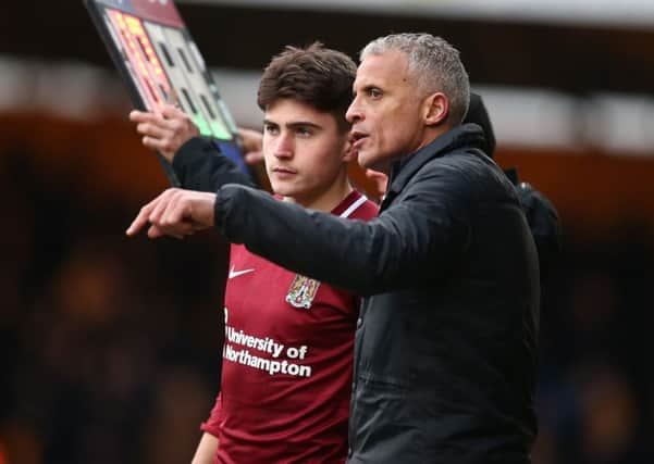 Scott Pollock gets instructions from Keith Curle as he prepares to make his Cobblers debut at Cambridge United last weekend (Picture: Pete Norton)