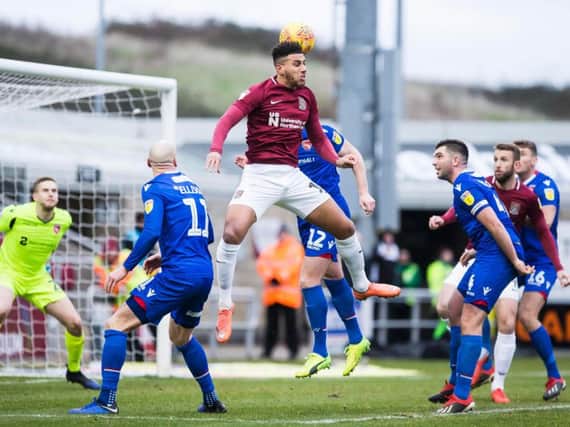 Daniel Powell flicks the ball on during the Cobblers' 1-1 draw with Morecambe on Saturday (Pictures: Kirsty Edmonds)