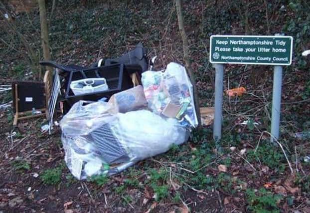 Works are underway to clear up this pile of rubbish but the council says a traveller encampment is delaying matters.