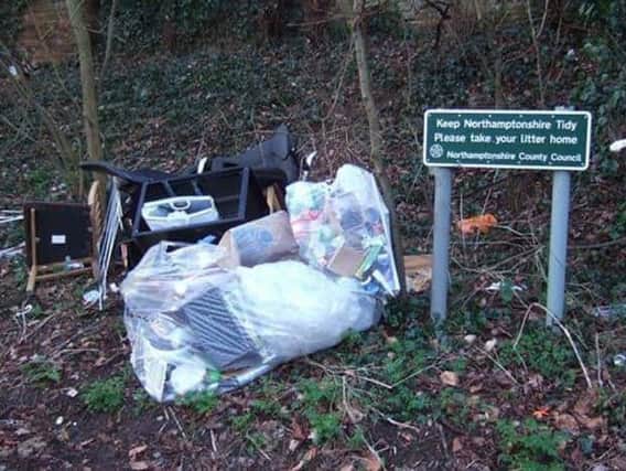 Works are underway to clear up this pile of rubbish but the council says a traveller encampment is delaying matters.