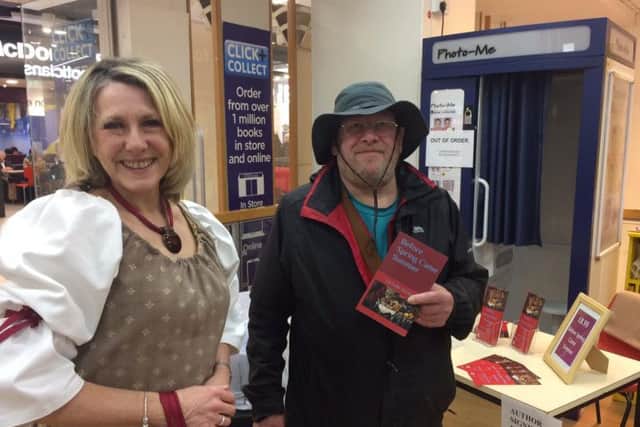 Michelle Hockley (left) signs a copy of Before Spring Came Summer for a happy customer.