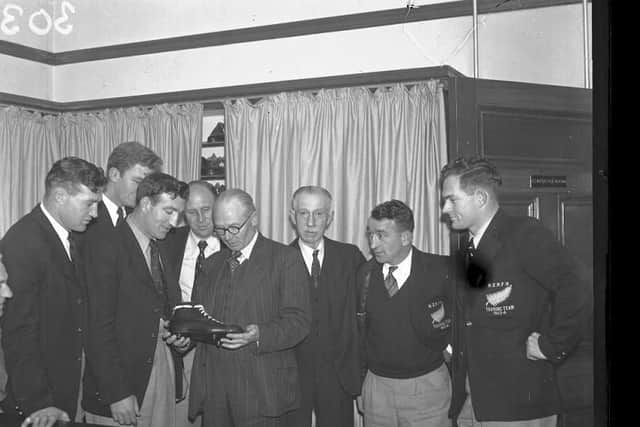 A New Zealand Rugby Football Union Touring Team 1953-54 admire a leather boot at a Northampton shoe factory