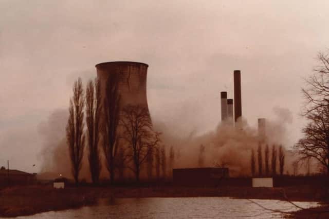 The cooling tower disappears in a cloud of dust and ash