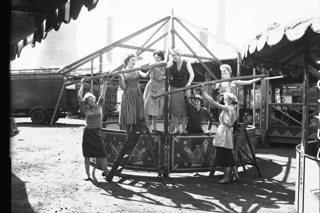 This photo shows the setting up of a fair at Midsummer Meadow, Northampton, on May 13, 1959 by an all-woman crew.
One cooling tower can be seen in the background of the picture.