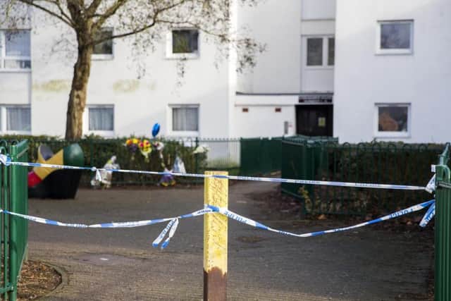 Seven bunches of flowers and a blue heart-shaped balloon have been left by the railings at the scene of a Northampton murder. Pictures: Kirsty Edmonds.
