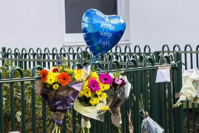 Seven bunches of flowers and a blue heart-shaped balloon were left by the railings at the scene of the murder