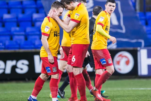 Ash Taylor congratulates Sam Hoskins after the Cobblers striker fired the Cobblers 2-1 ahead at Tranmere (Pictures: Kirsty Edmonds)