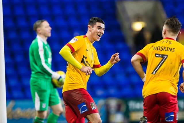 Happy Cobblers: Joe Powell congratulates goalscorer Sam Hoskins. Pictures: Kirsty Edmonds