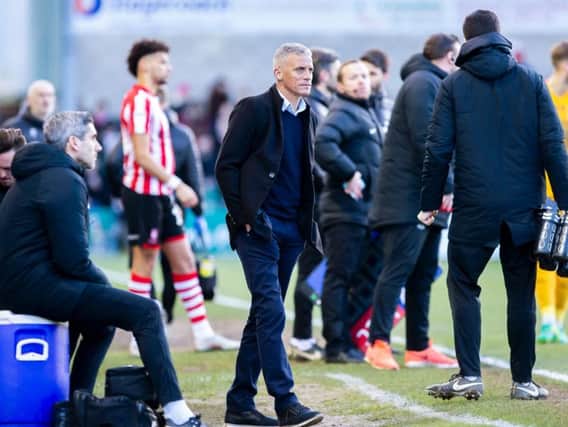 Keith Curle and opposite number Danny Cowley gave the fourth official a busy afternoon at Sincil Bank. Picture: Kirsty Edmonds