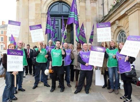 Unions say they want a return to national pay and conditions for Northamptonshire County Council staff.