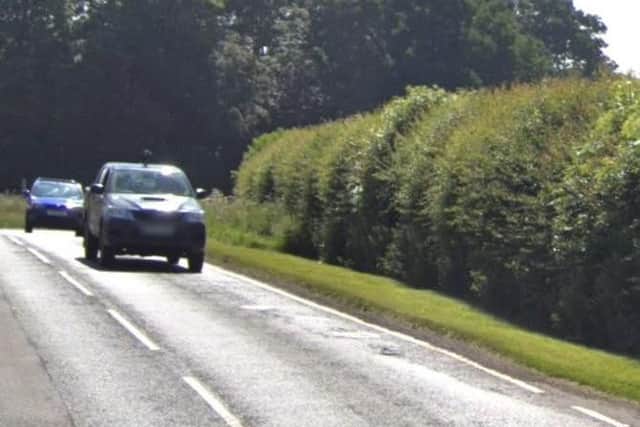 A silver Range Rover crashed through a hedge and overturned on Roman Road.