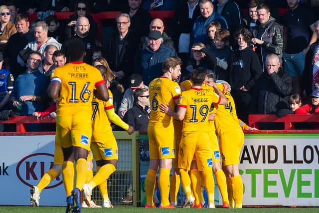 Cobblers celebrate Joe Powell's first-half opener. Pictures: Kirsty Edmonds