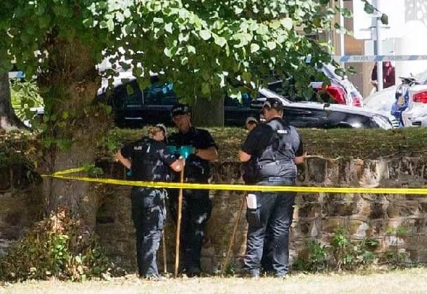 Police officers examining the scene on August 7, 2018
