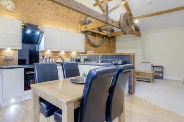 The original winch and pulley system has been retained in the overhead beams of the top floor apartment