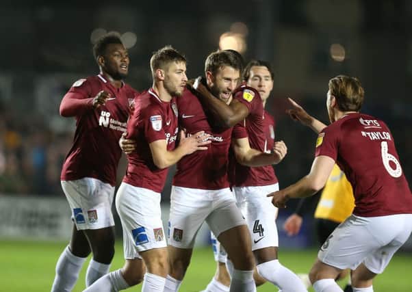Cobblers celebrate Andy Williams' equaliser at Rodney Parade. Pictures: Pete Norton/Getty Images)