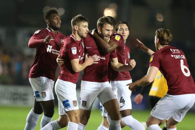Cobblers celebrate Andy Williams' equaliser at Rodney Parade. Pictures: Pete Norton/Getty Images)