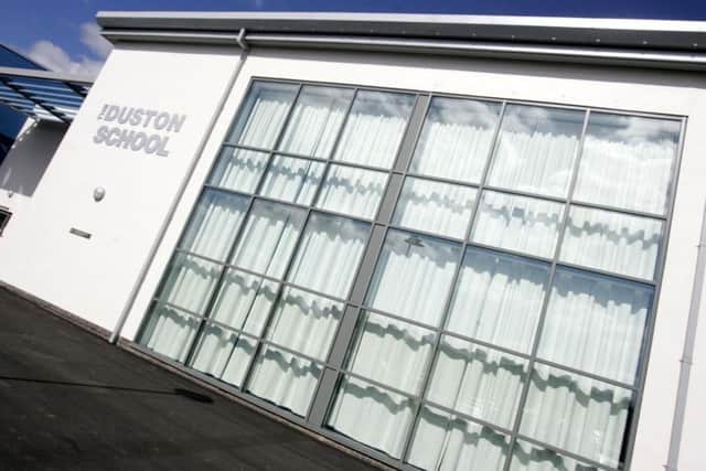 The Duston School has issued a warning after a group of pupils were approached by a man behaving strangely on their way home.