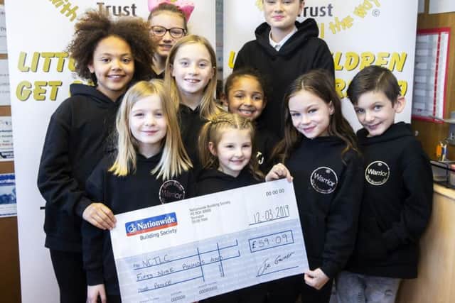 Gracie and her eight friends from Razzle Dazzle Stage School handed over a cheque on Tuesday night to NCTLC, a charity which previously paid for the nine-year-old and her family to go to Disneyland Paris.